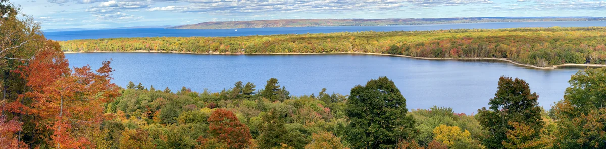 Autumn trees around Monocle Lake with Lake Superior and the distant shore beyond