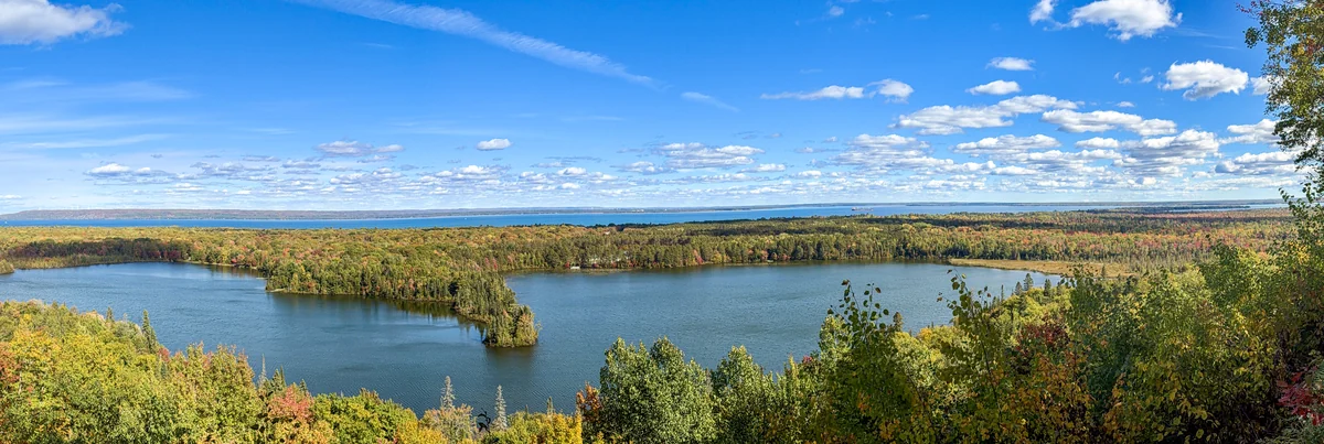Wide autumn panorama of the wooded peninsula and lakes