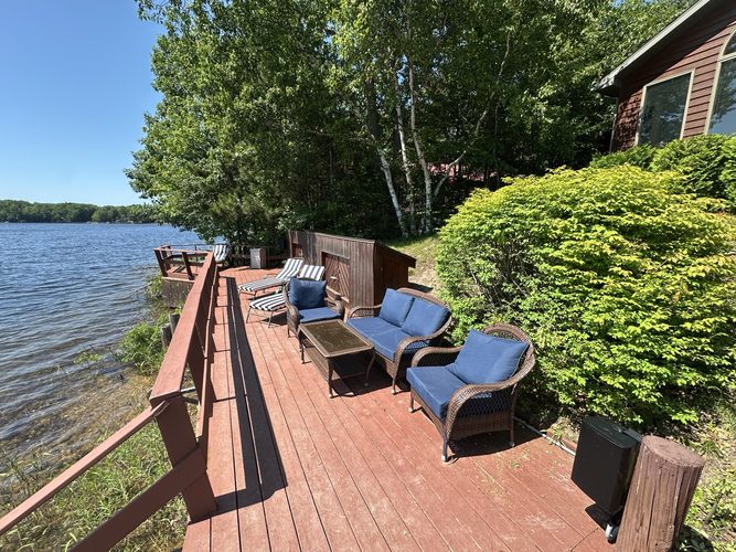 Waterfront deck seating at the edge of the lake